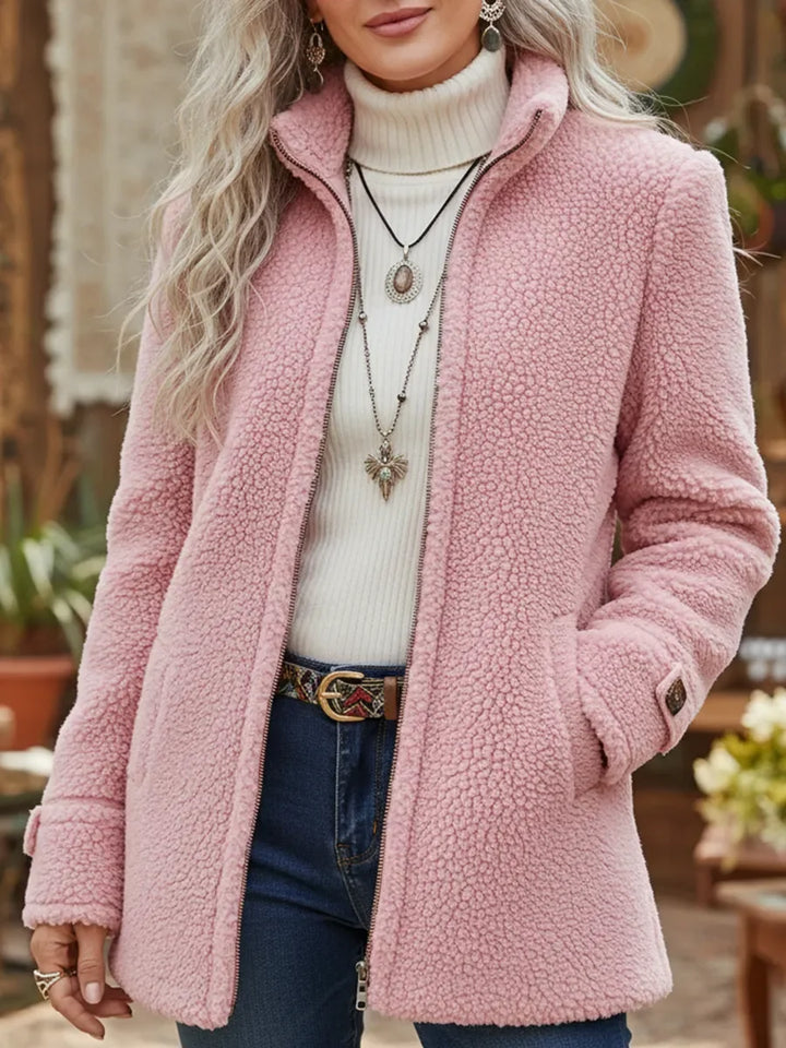 Front view showing stand collar, full-length zipper and side pockets, pink