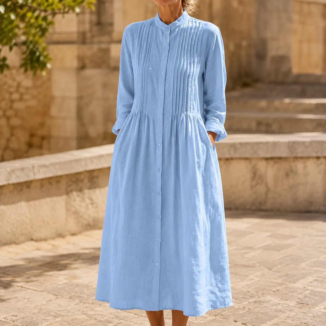 Front view of stand collar, pintuck bodice, button placket and gathered skirt