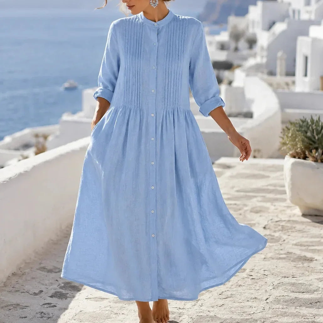 Front view of pintuck bodice, side pockets and gathered skirt, blue