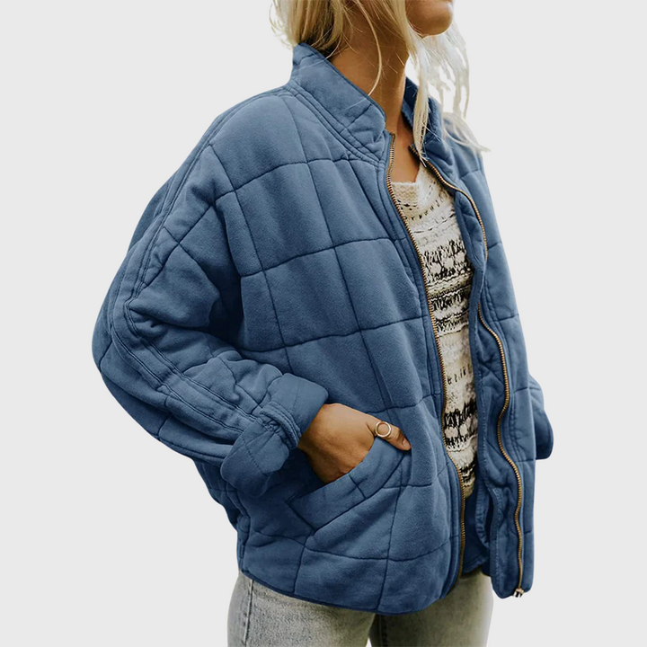 Front view showing stand collar, zipper front and side pocket, blue