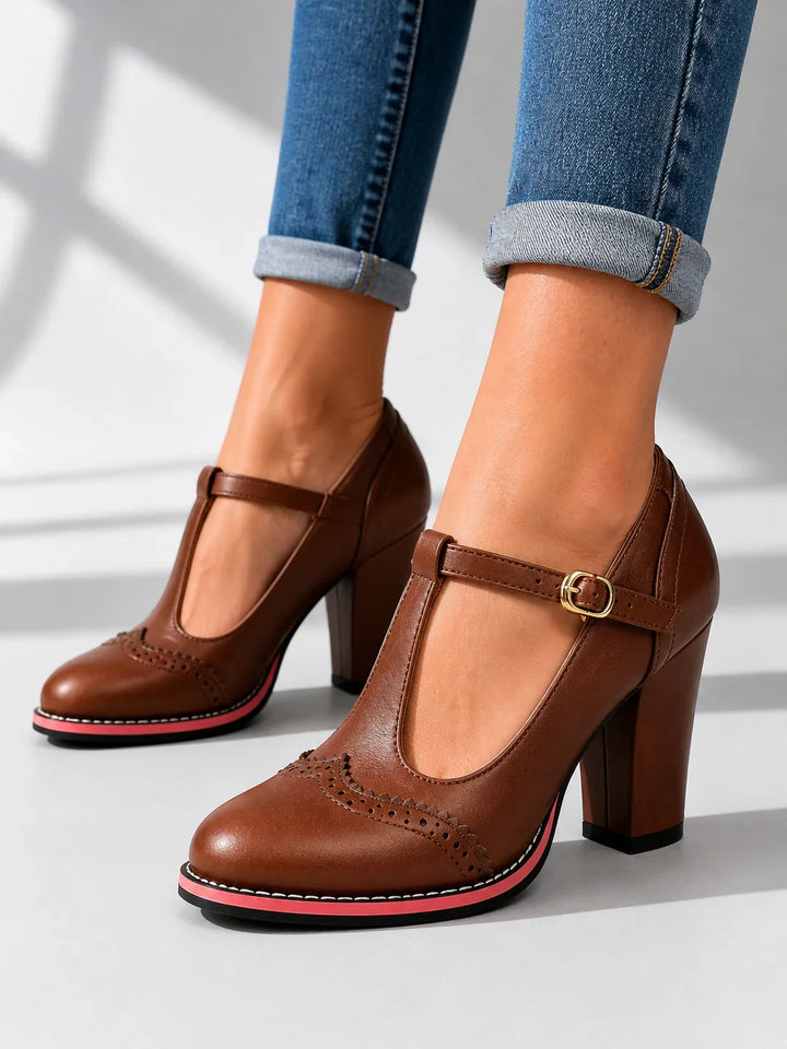 Side view of t-bar strap, buckle, brogue toe and block heel, brown