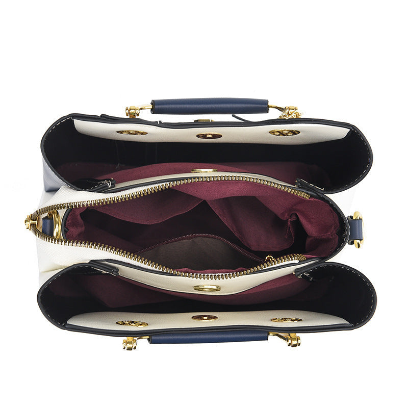 Detail view of open top showing three compartments and middle zipper