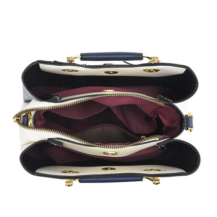 Detail view of open top showing three compartments and middle zipper