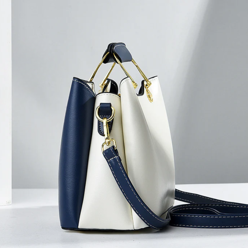 Side view of side panel, top handle and crossbody strap