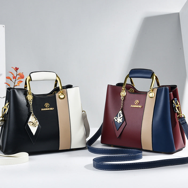 Front view of two bags showing top handles and color-block bodies