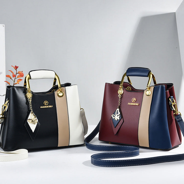 Front view of two bags showing top handles and color-block bodies