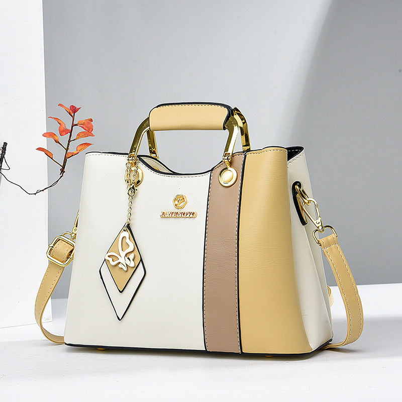 Front view of top handle, butterfly charm and color-block body