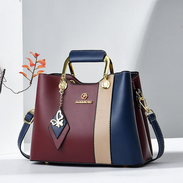 Front view of top handle, butterfly charm and color-block panels