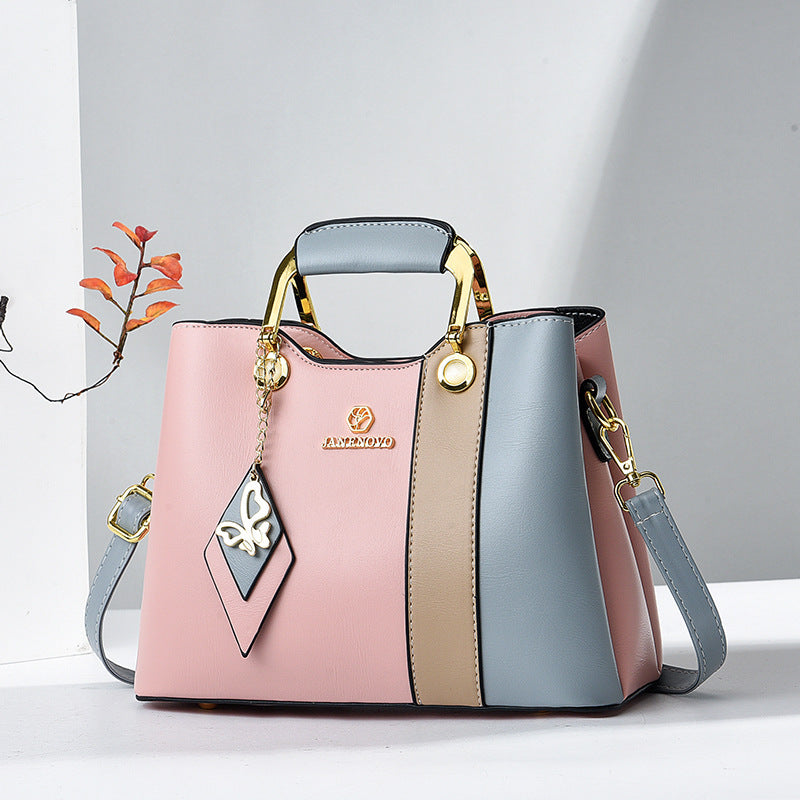 Front view of top handle, butterfly charm and color-block body