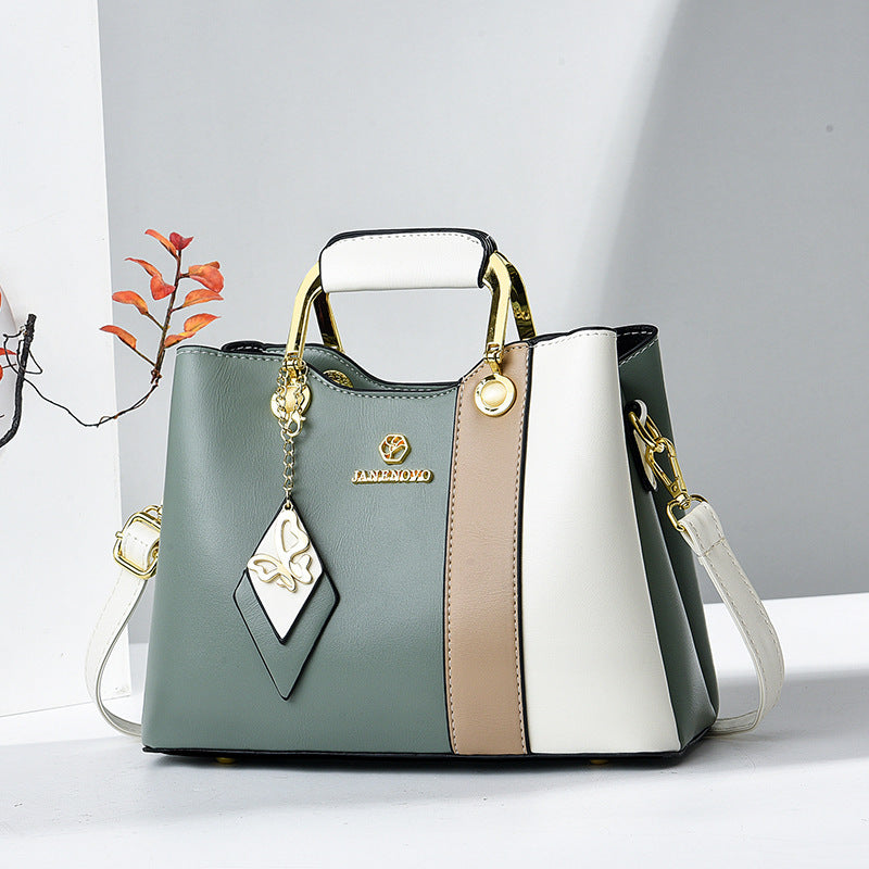 Front view of top handle, butterfly charm and color-block panels