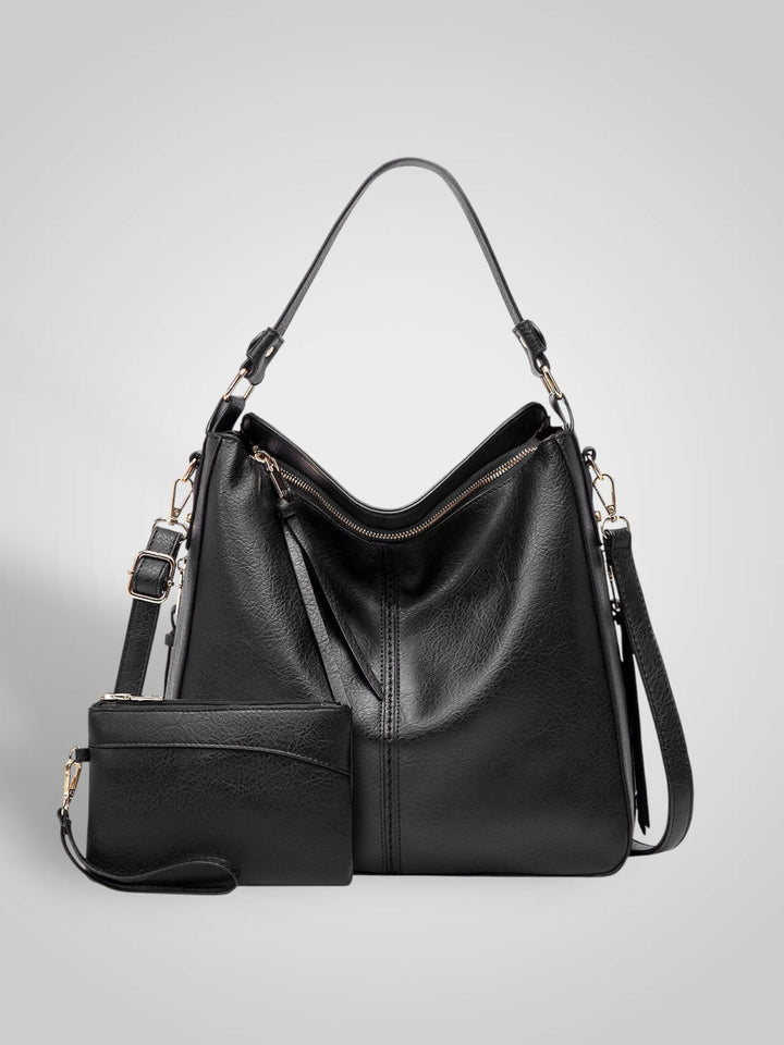 Front view with top handle, crossbody strap, top zipper closure and matching pouch, black