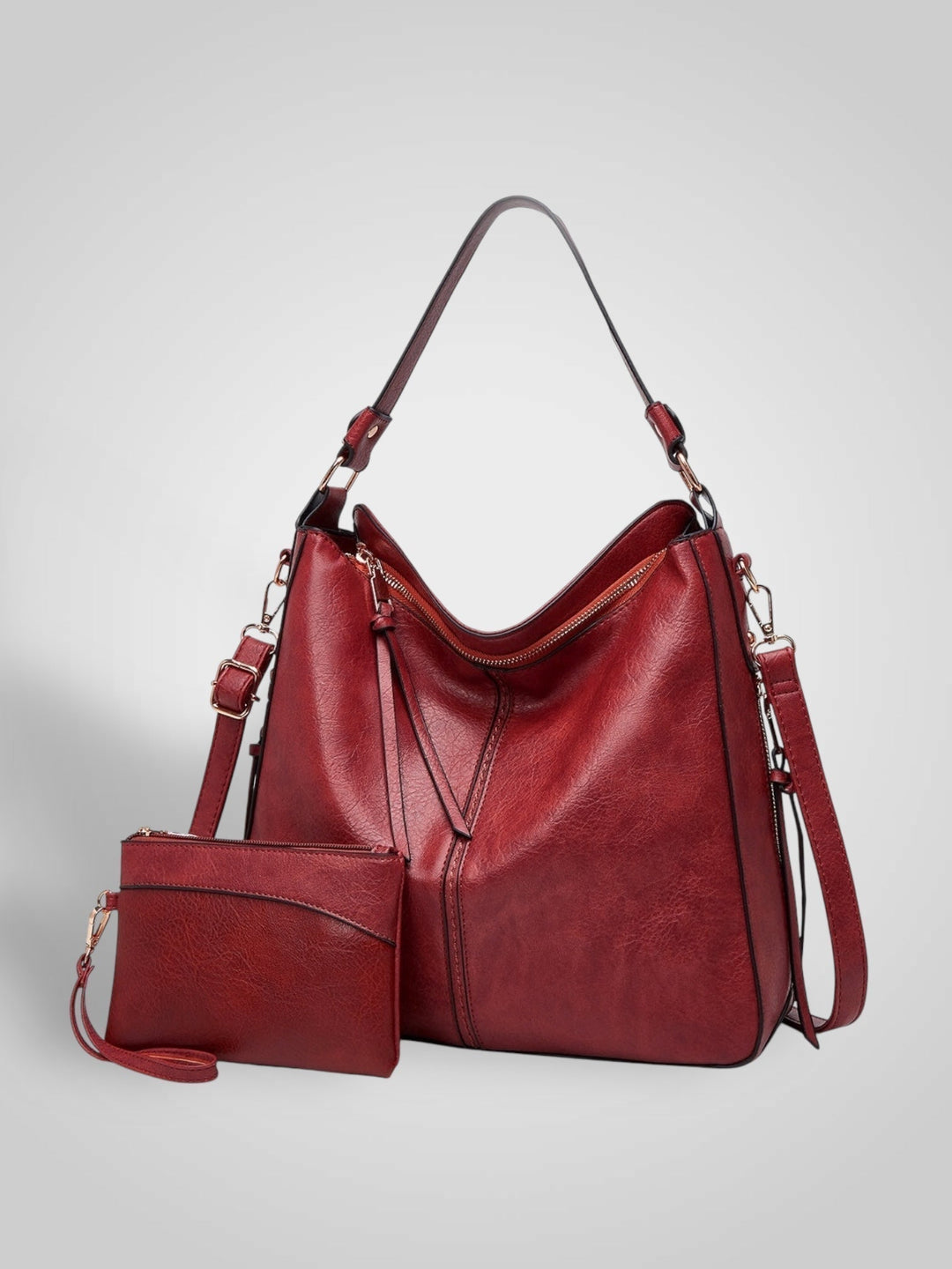 Front view with top handle, crossbody strap, top zipper closure and matching pouch, red