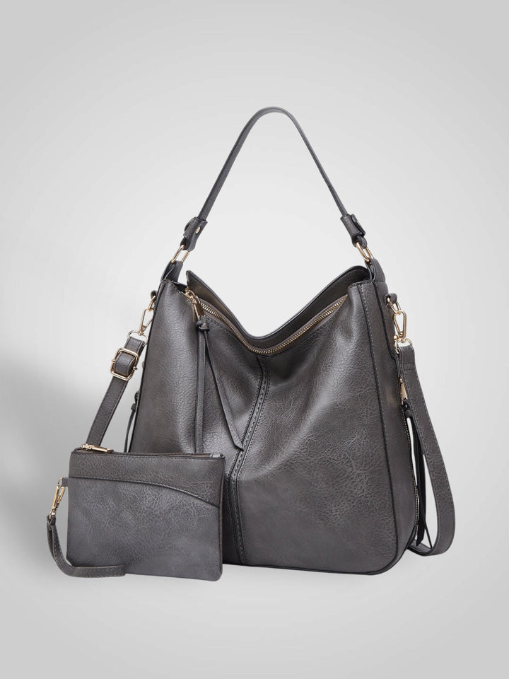 Front view with top handle, crossbody strap, top zipper closure and matching pouch, gray