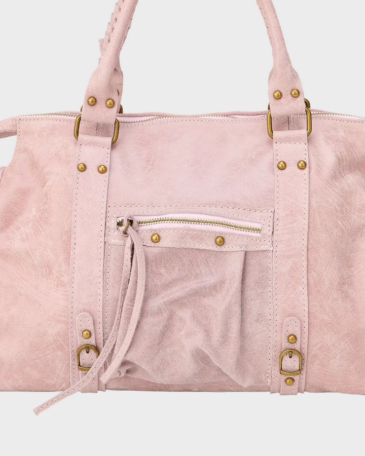 Detail view of the front zipper pocket, studs and buckles