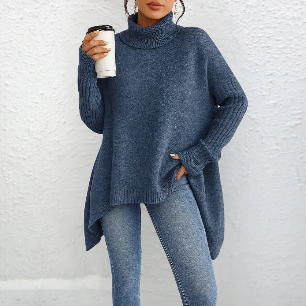 Front view showing turtleneck, long sleeves and asymmetric hem, blue