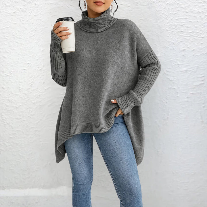 Front view showing turtleneck, dropped shoulder seams and banded cuffs, gray