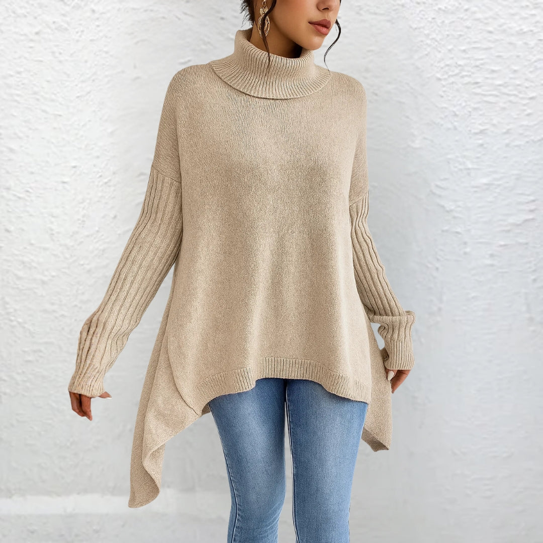 Front view showing turtleneck, dropped shoulder seams and asymmetric hem