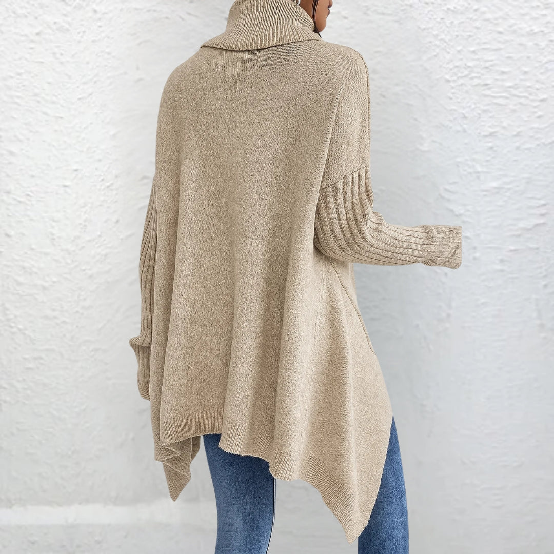 Back view showing turtleneck, ribbed sleeves and asymmetric hem