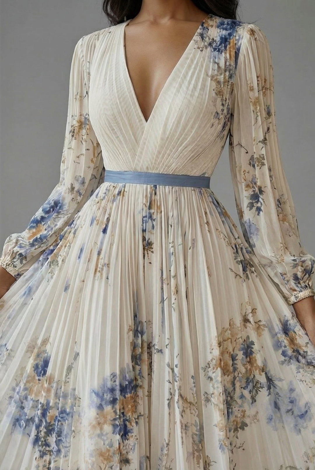 Detail view of v-neckline, pleated bodice and banded waist