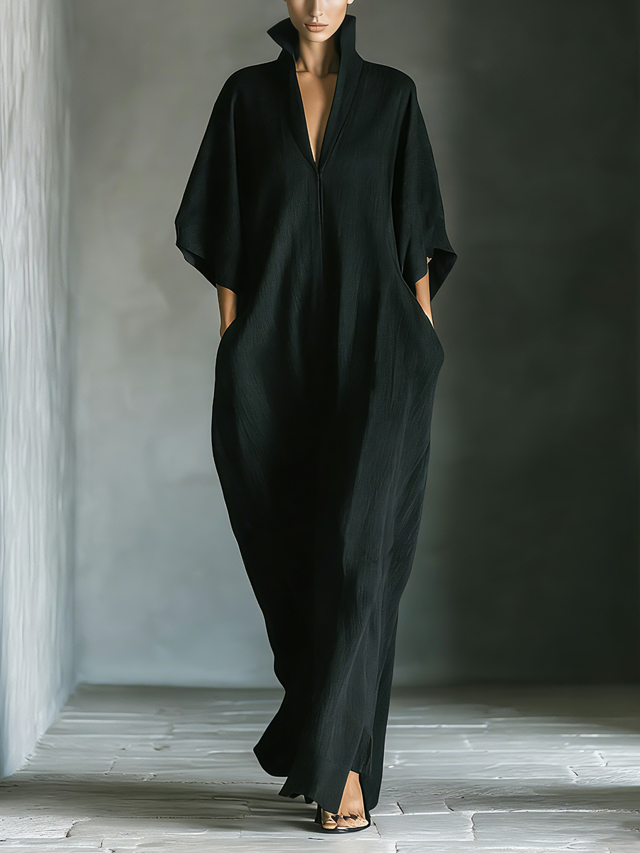 Front view of maxi dress with stand collar, v-neckline, wide kimono sleeves and side pockets, black