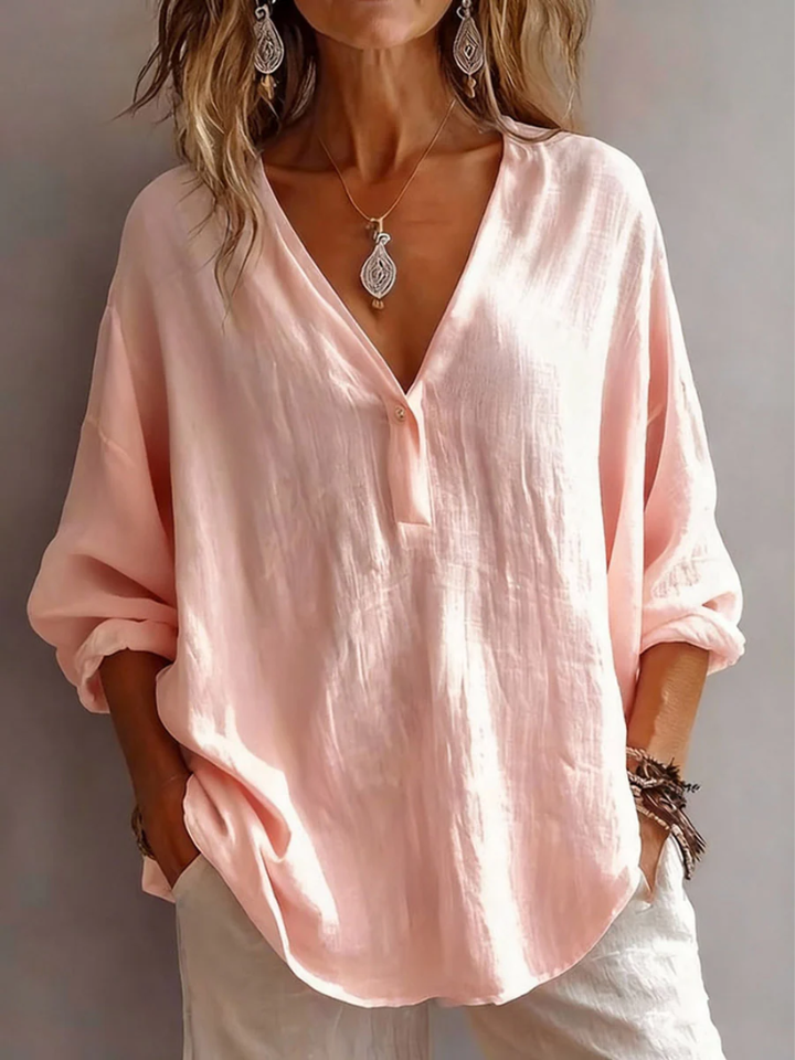 Front view showing deep v-neckline, button placket and long sleeves, pink