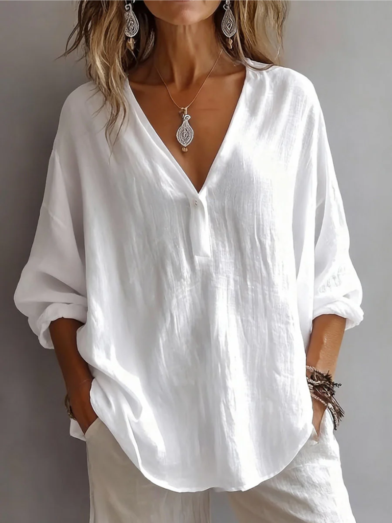 Front view showing deep v-neckline, button placket and curved hem, white