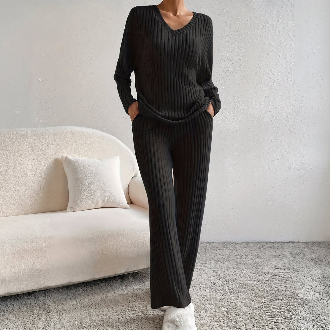 Front view of co-ord set showing v-neckline, long sleeves, side pockets and wide legs, black