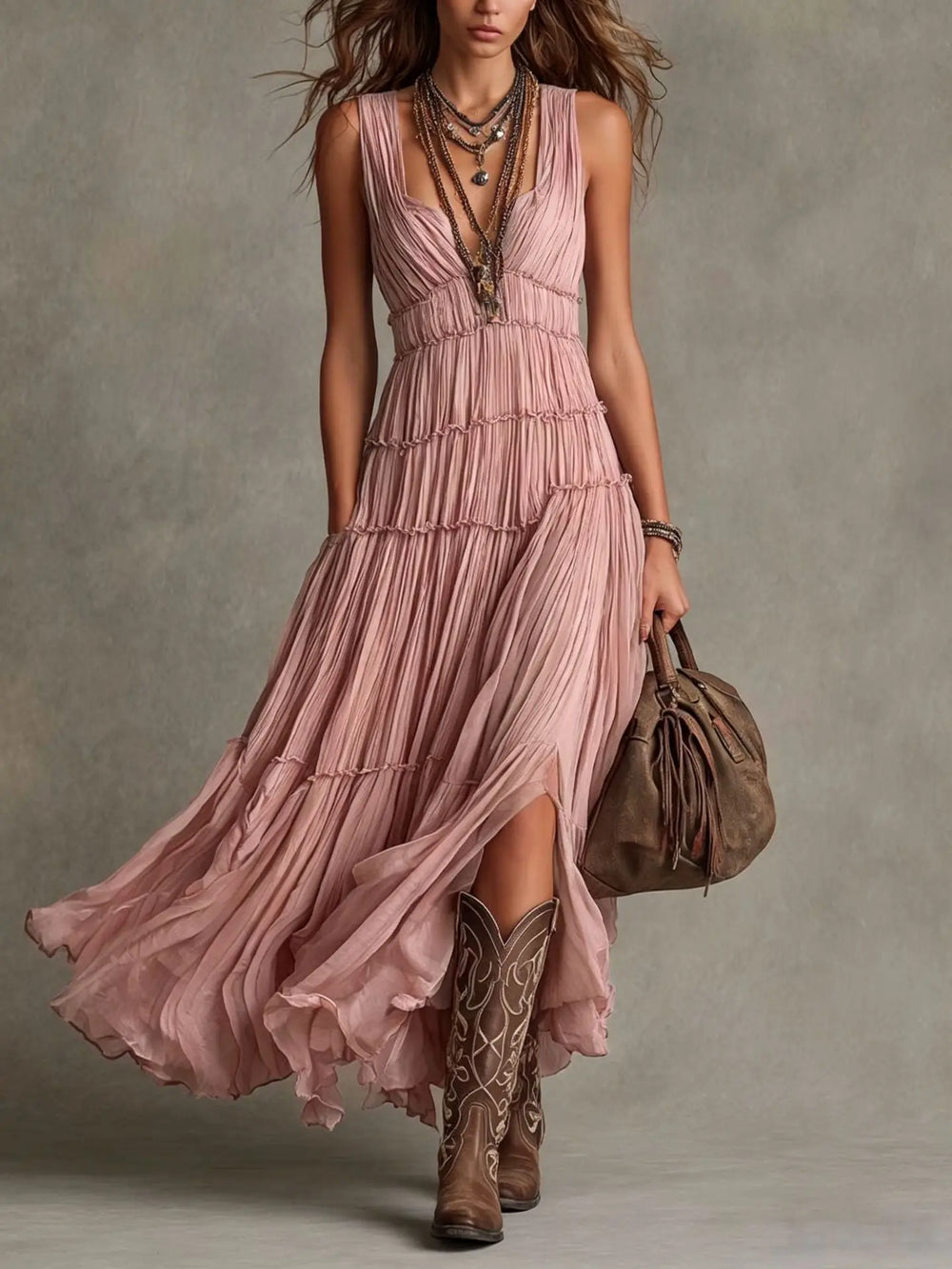 Front view of deep V-neckline, pleated bodice and tiered skirt, pink