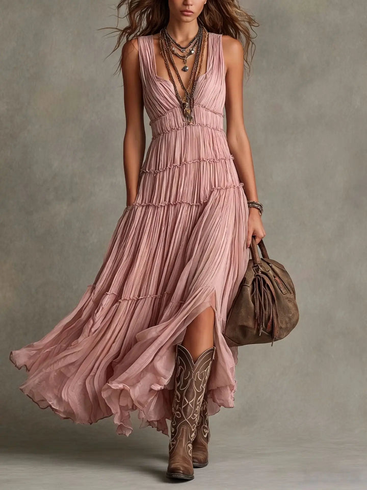 Front view of deep V-neckline, pleated bodice and tiered skirt, pink