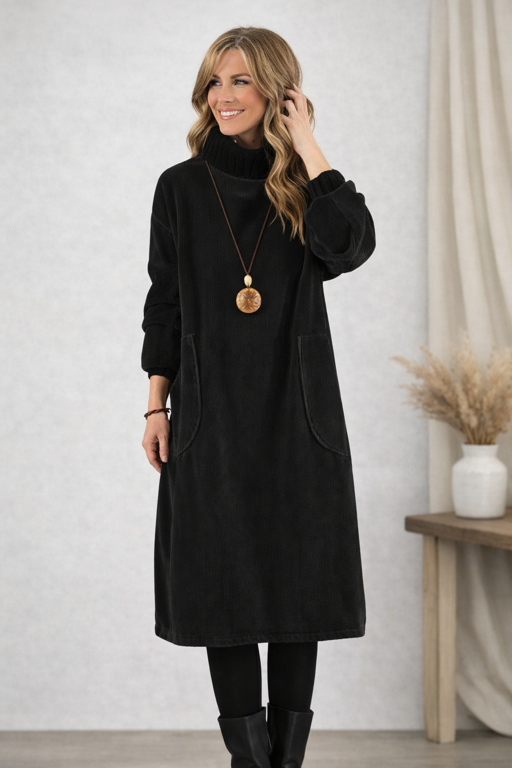 Front view of turtleneck midi dress with long sleeves and patch pockets, black