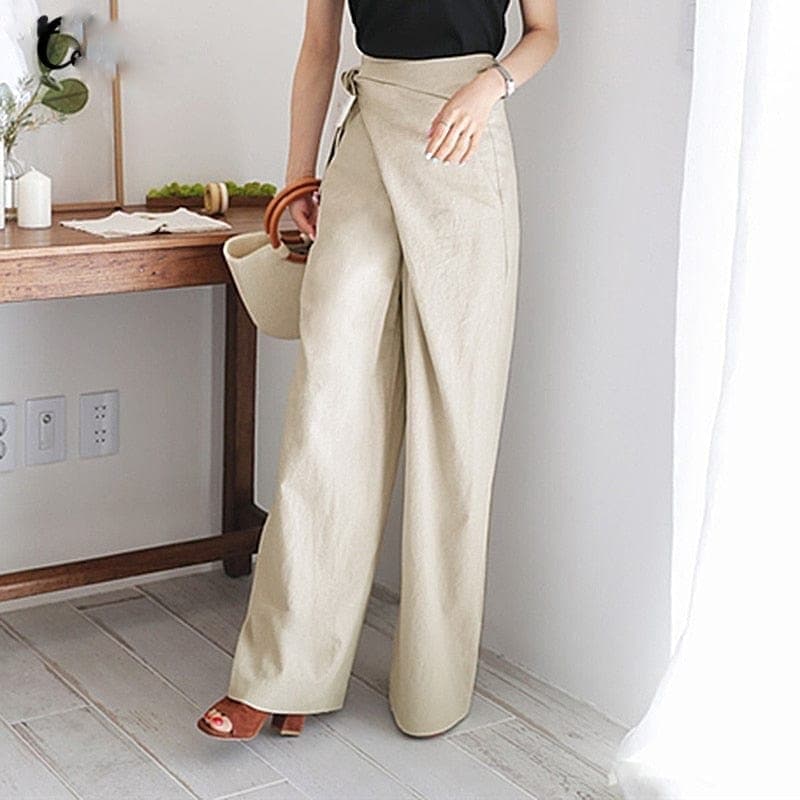 Front view of wrap front pants with side tie and wide legs, beige